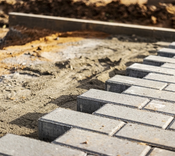 pavement-repairs-paving-slabs-laying-prepared-surface-with-tile-cubes-background-laying-paving-slabs-pedestrian-zone-city-paving-slabs-curbs